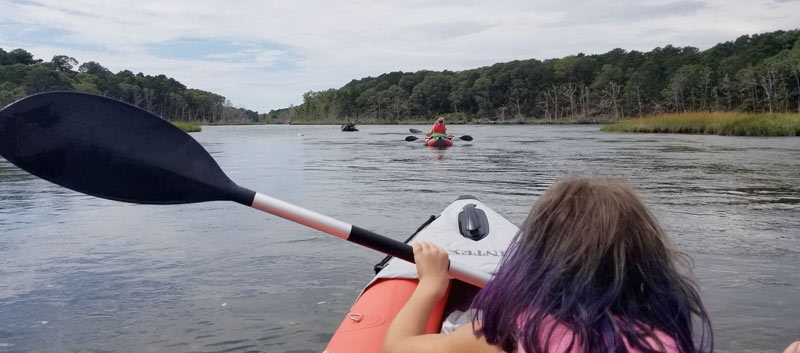 A girl kayaking on Cape Cod.