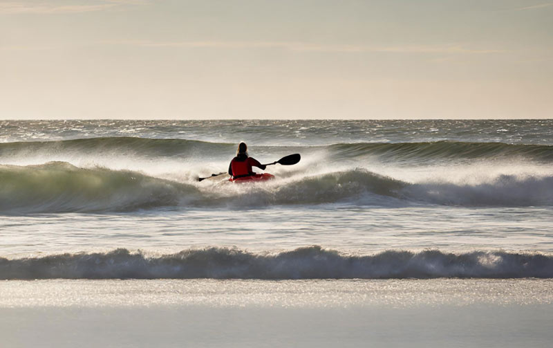 Kayaking in Wellfleet, MA, in the waves of white crest beach.